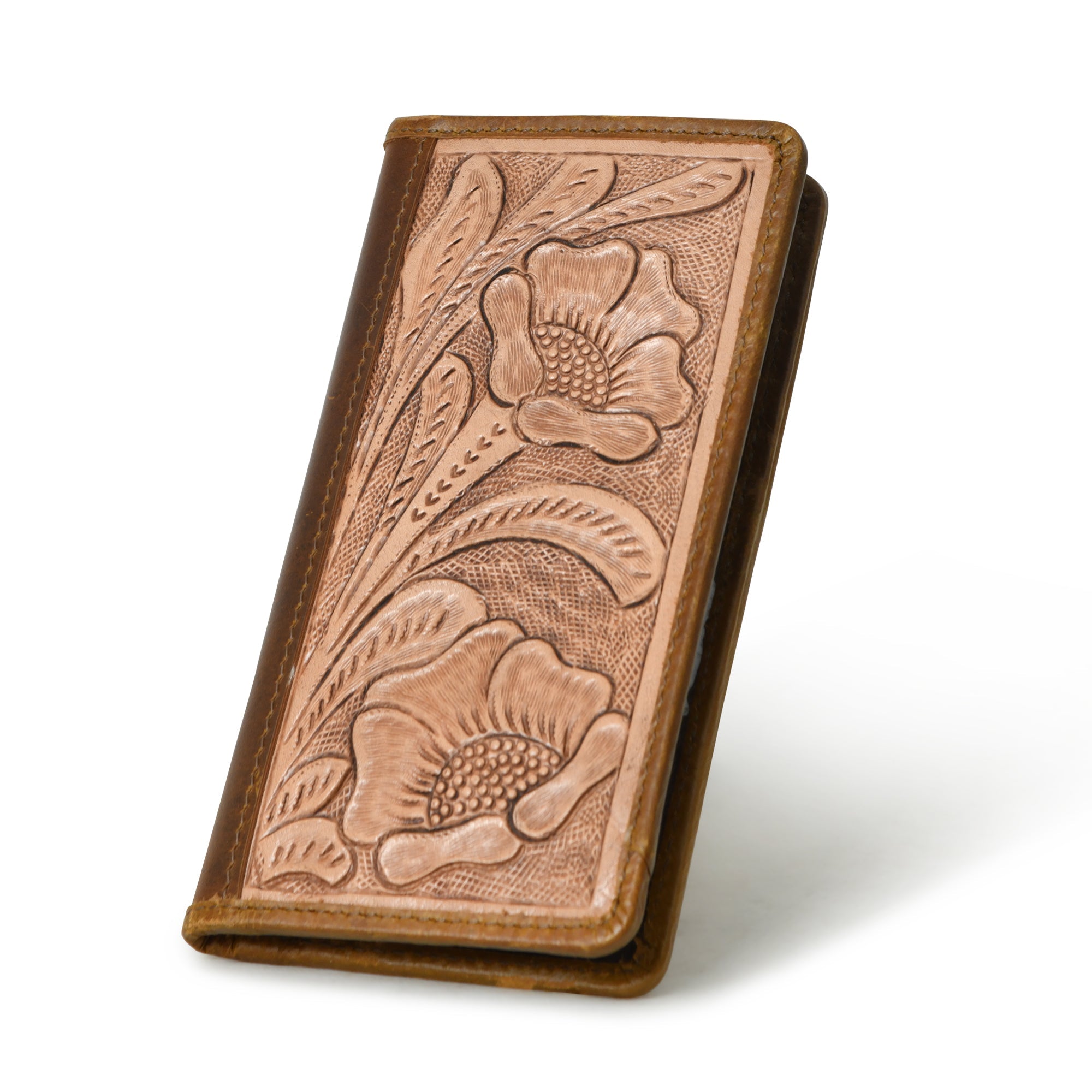 Brown leather bifold wallet with tooled floral design, standing upright.