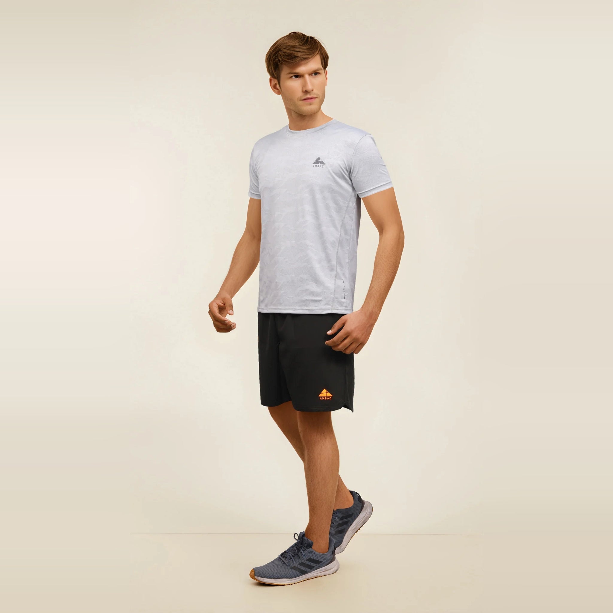 Man wearing a blue, dry-fit, crew neck t-shirt, ideal for workouts and staying cool during exercise.