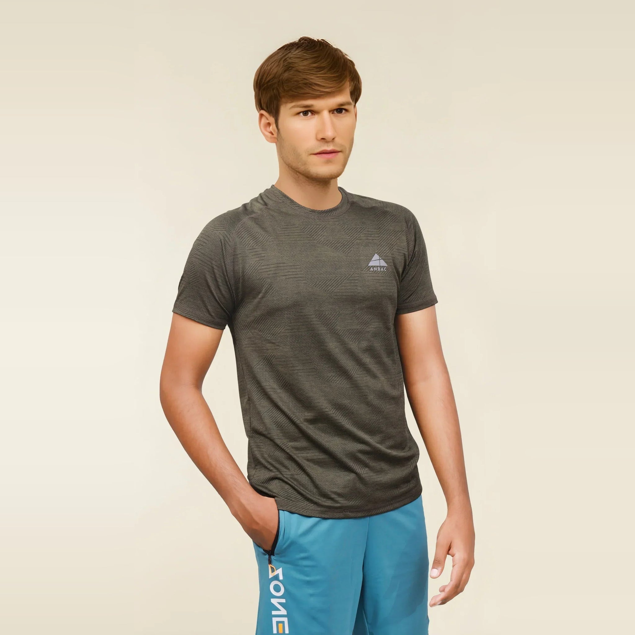 Man in a grey dry fit short sleeve crew neck t-shirt.