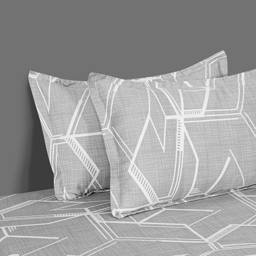 Gray king-size bedsheets with a modern white geometric hexagonal pattern, shown with matching pillowcases.