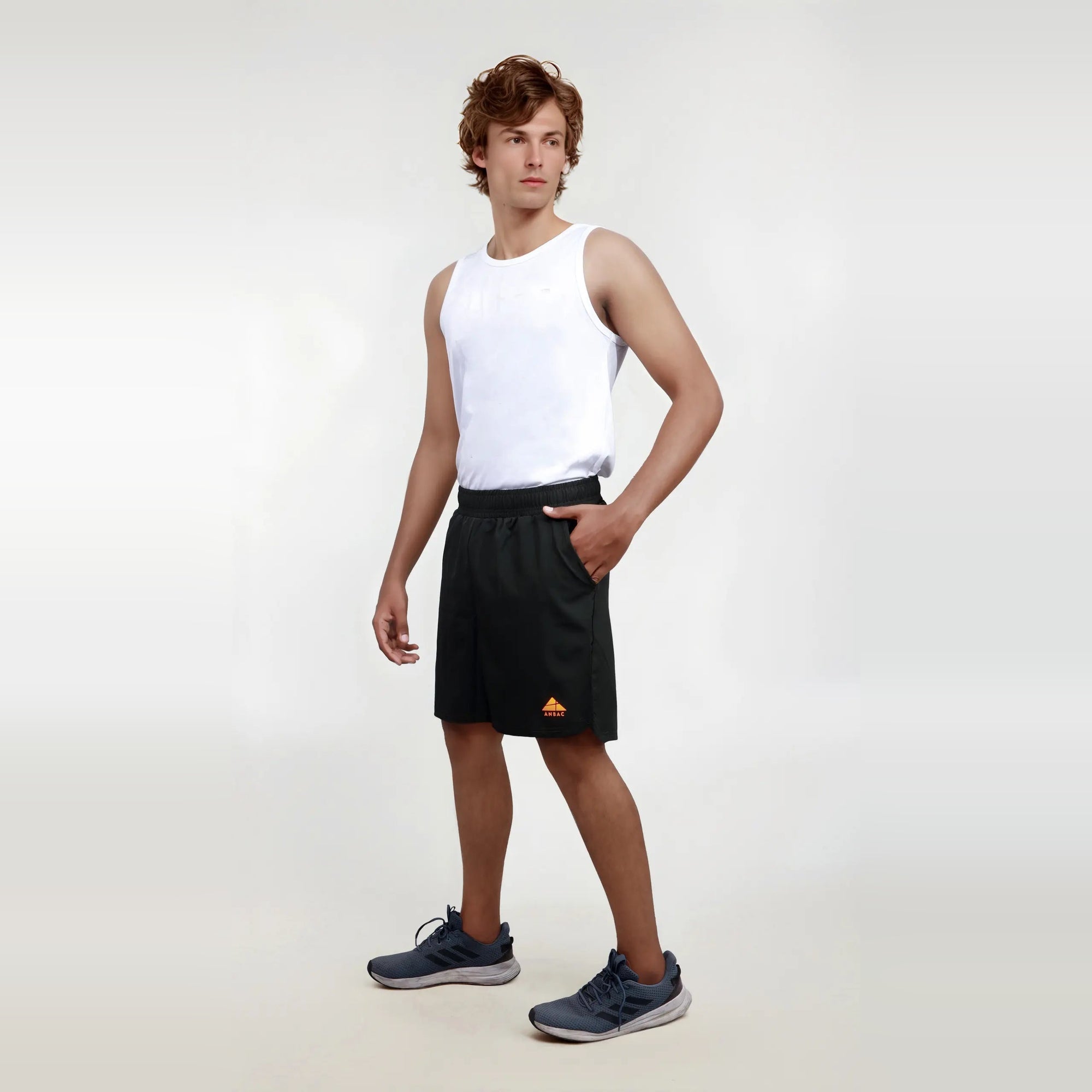 Man wearing black wrinkle-free, dry-fit shorts perfect for sports and the gym.