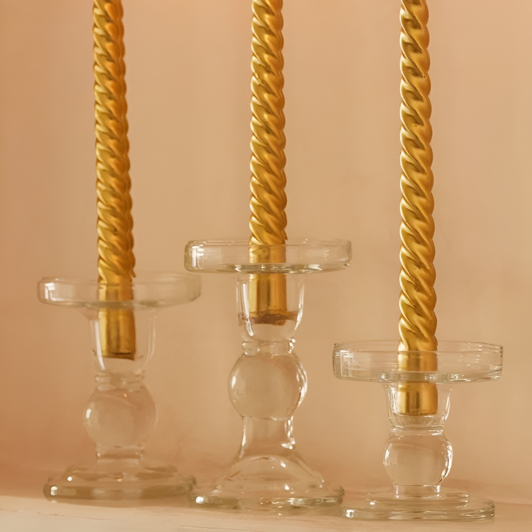 Three clear glass Paradise candle holders in small, medium, and large sizes, perfect for displaying elegant candles.