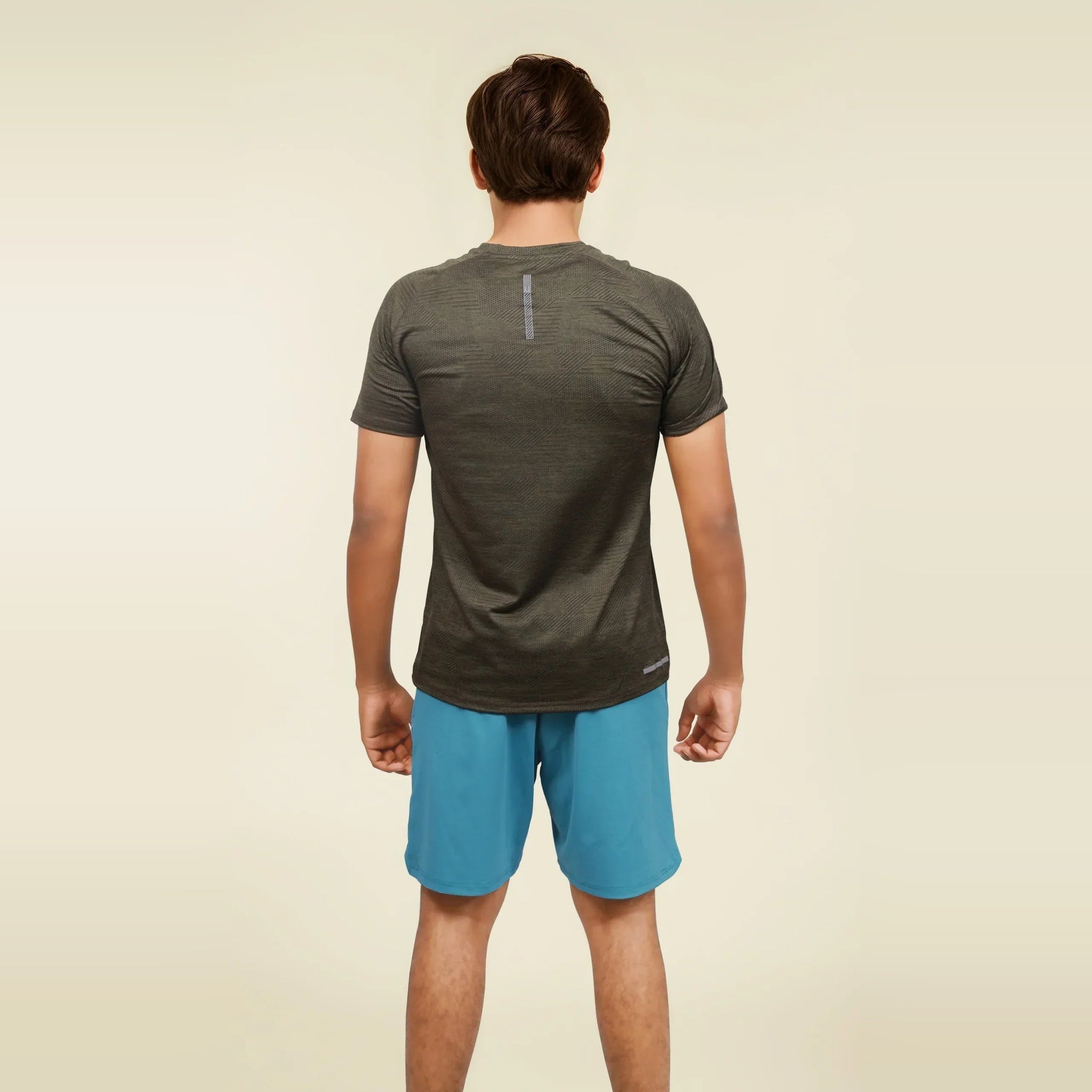 Man wearing a dry fit, short sleeve, crew neck t-shirt, back view.