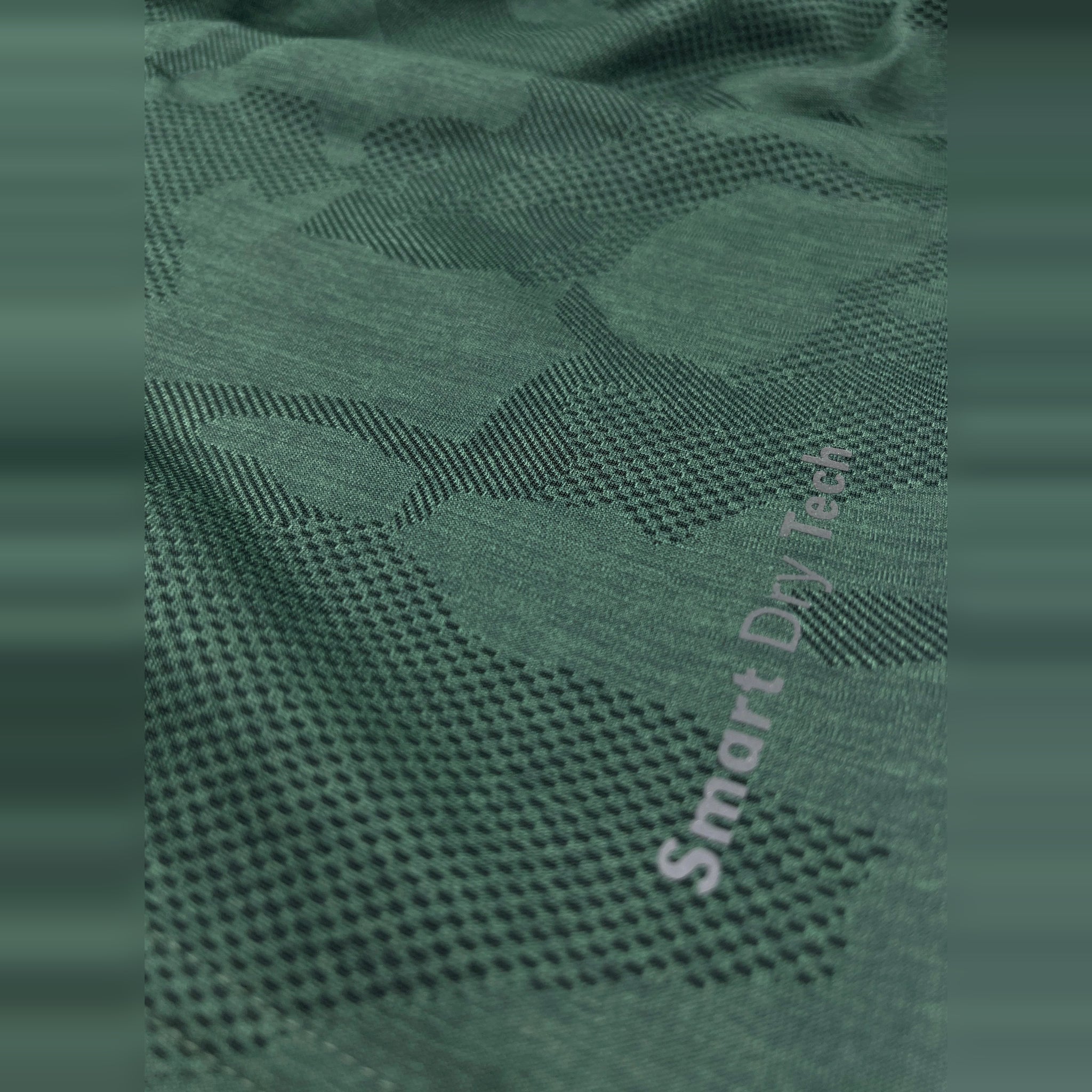 Close-up view of the breathable, green fabric of a men's Dry-Fit workout t-shirt, designed for comfort and performance.