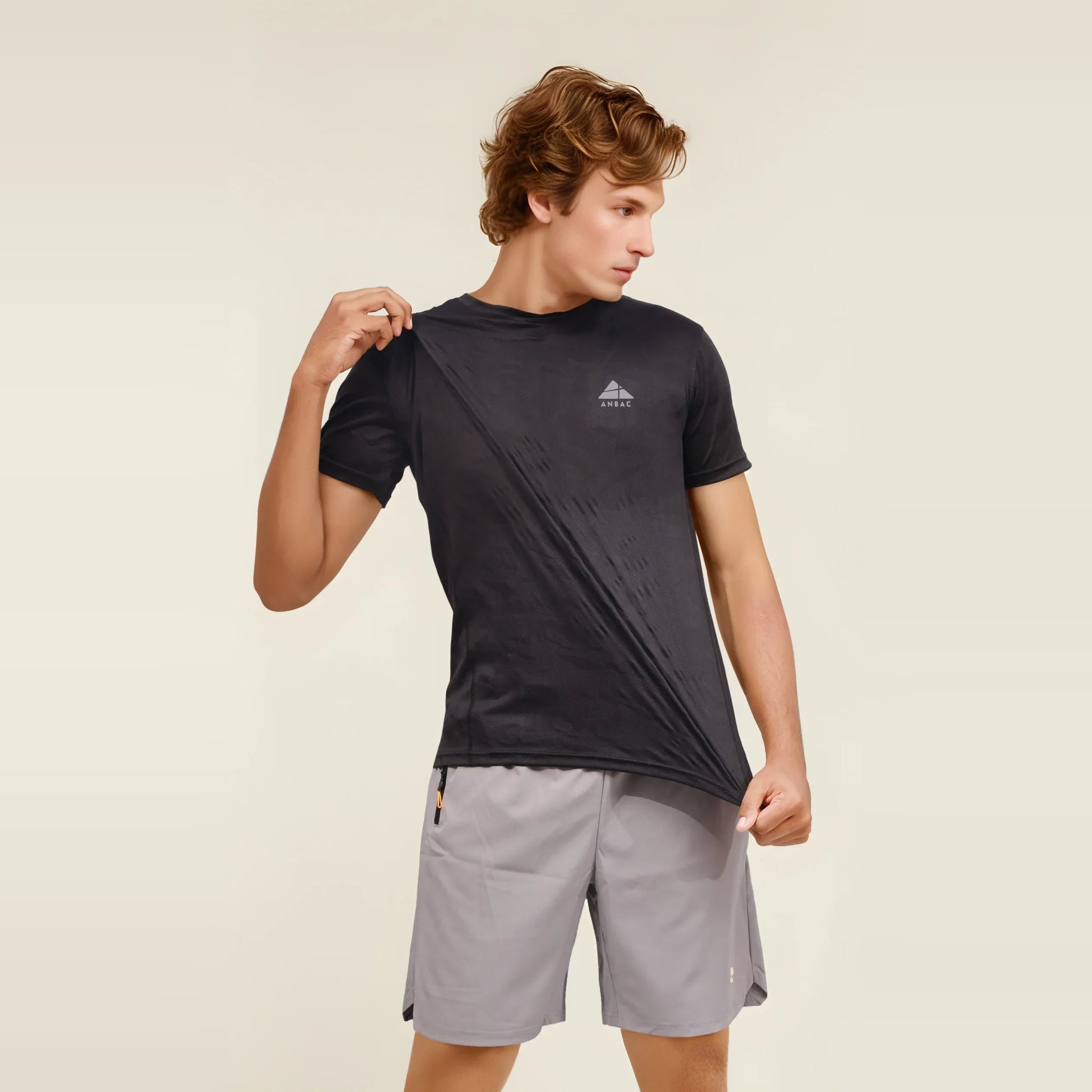 Man wearing a black Dry-Fit crew neck T-shirt, designed for comfortable workouts.