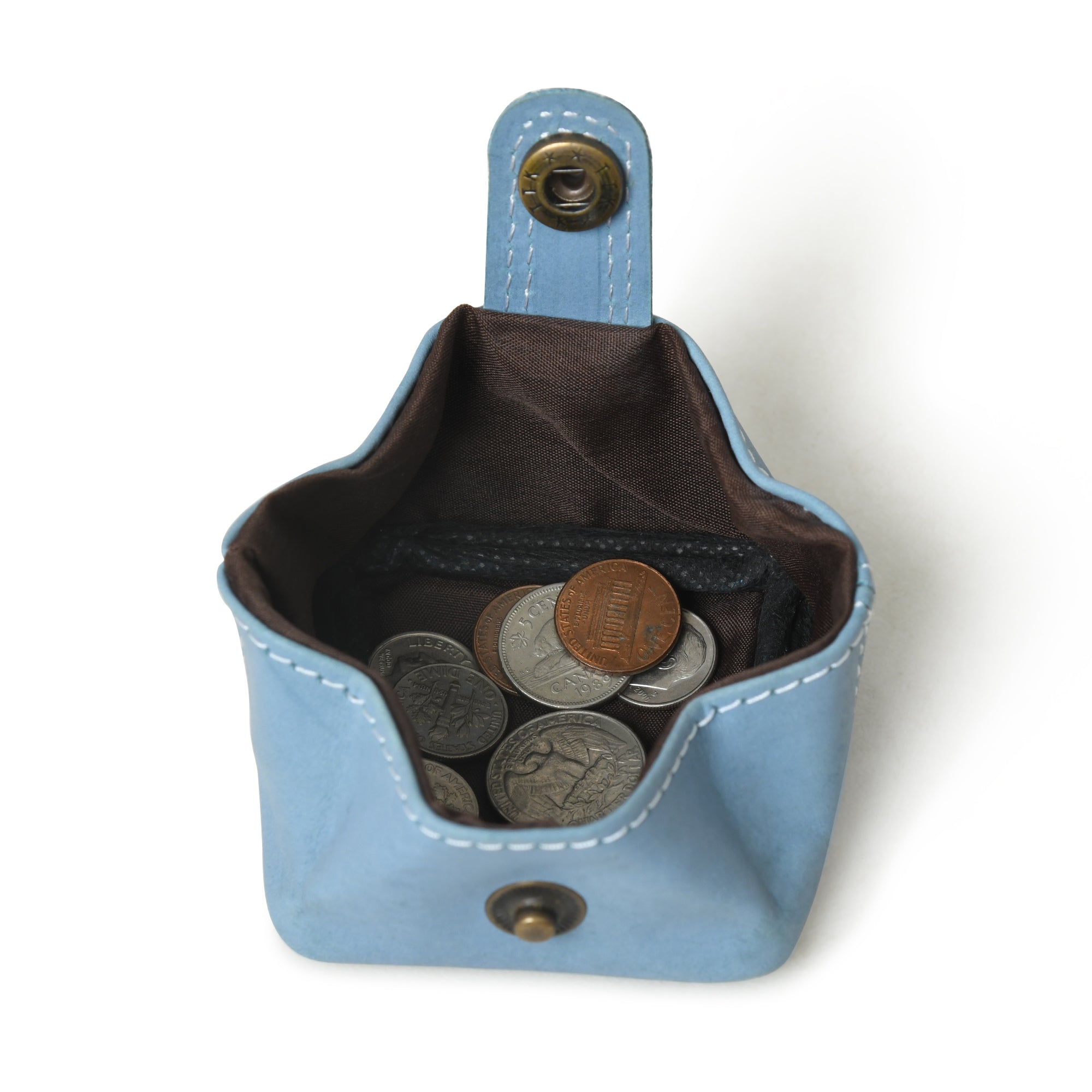 Open blue leather coin purse filled with coins. Stylish and slim premium leather pouch, perfect for carrying your change.