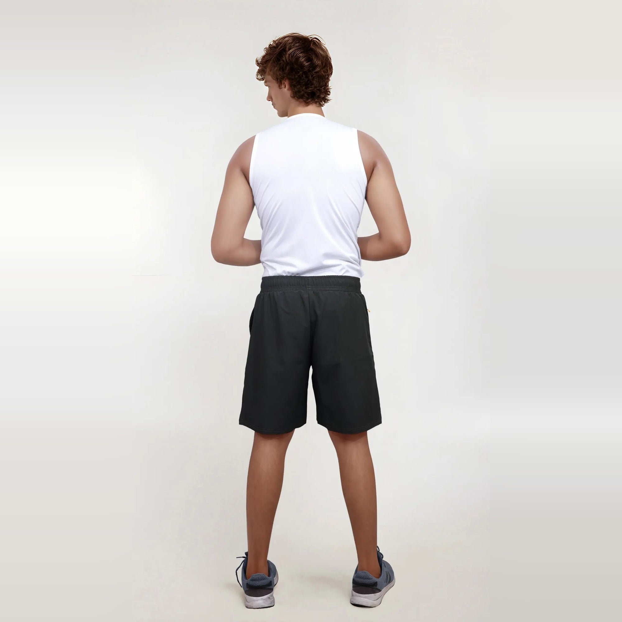 Man wearing wrinkle-free, dry-fit shorts, perfect for sports and gym workouts.