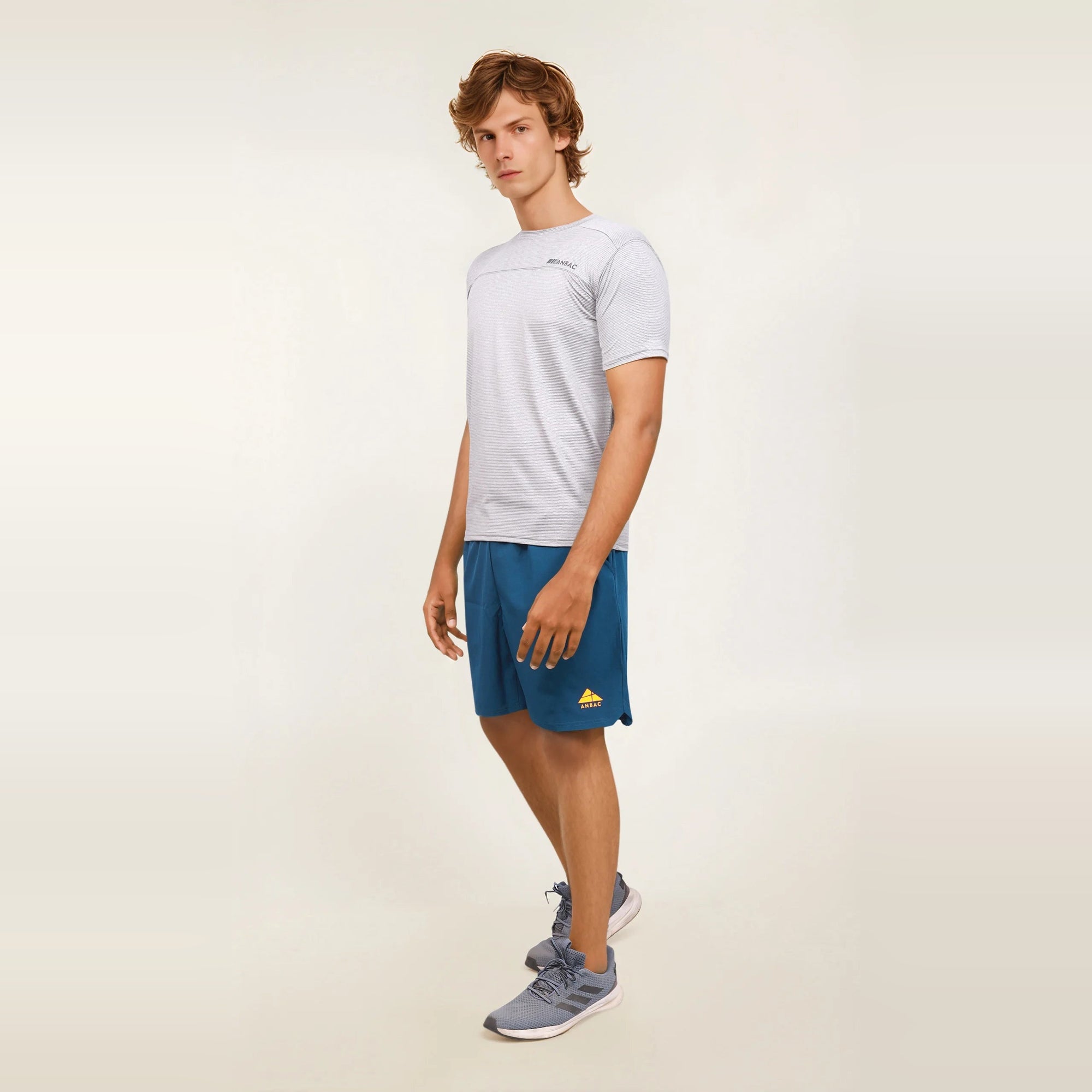 Man modeling a light gray, slim-fit, short sleeve men's t-shirt.