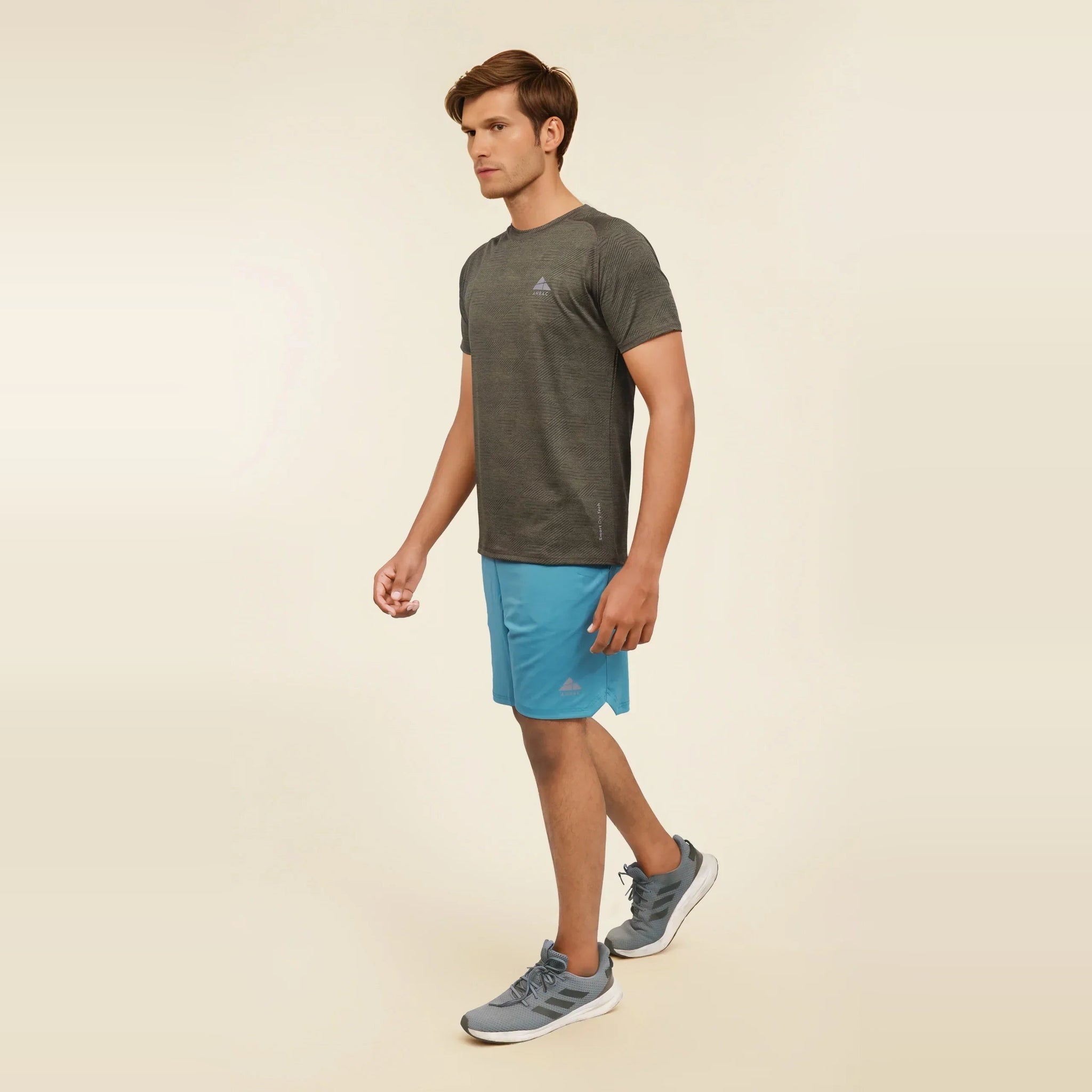 Man walking in a dry fit, crew neck, short sleeve athletic t-shirt.