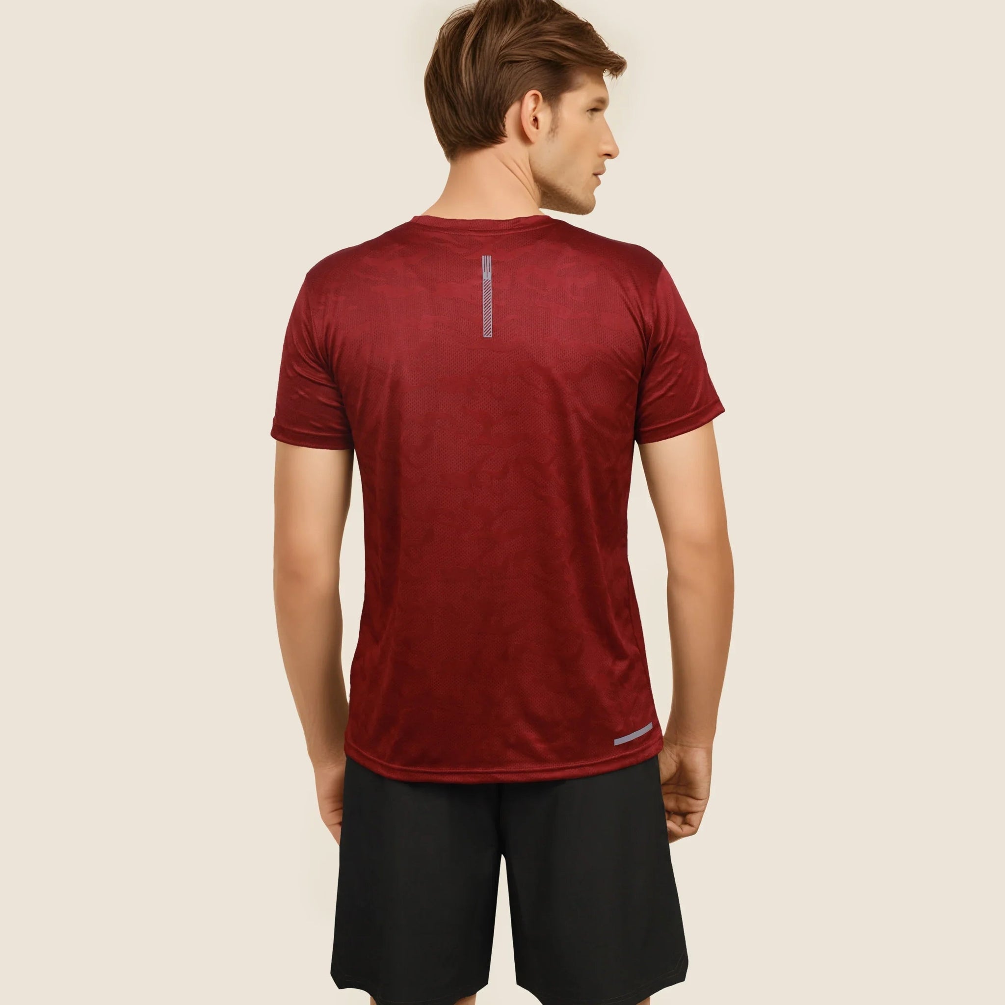 Man wearing a maroon dry-fit crew neck t-shirt, ideal for workouts and staying cool and comfortable.