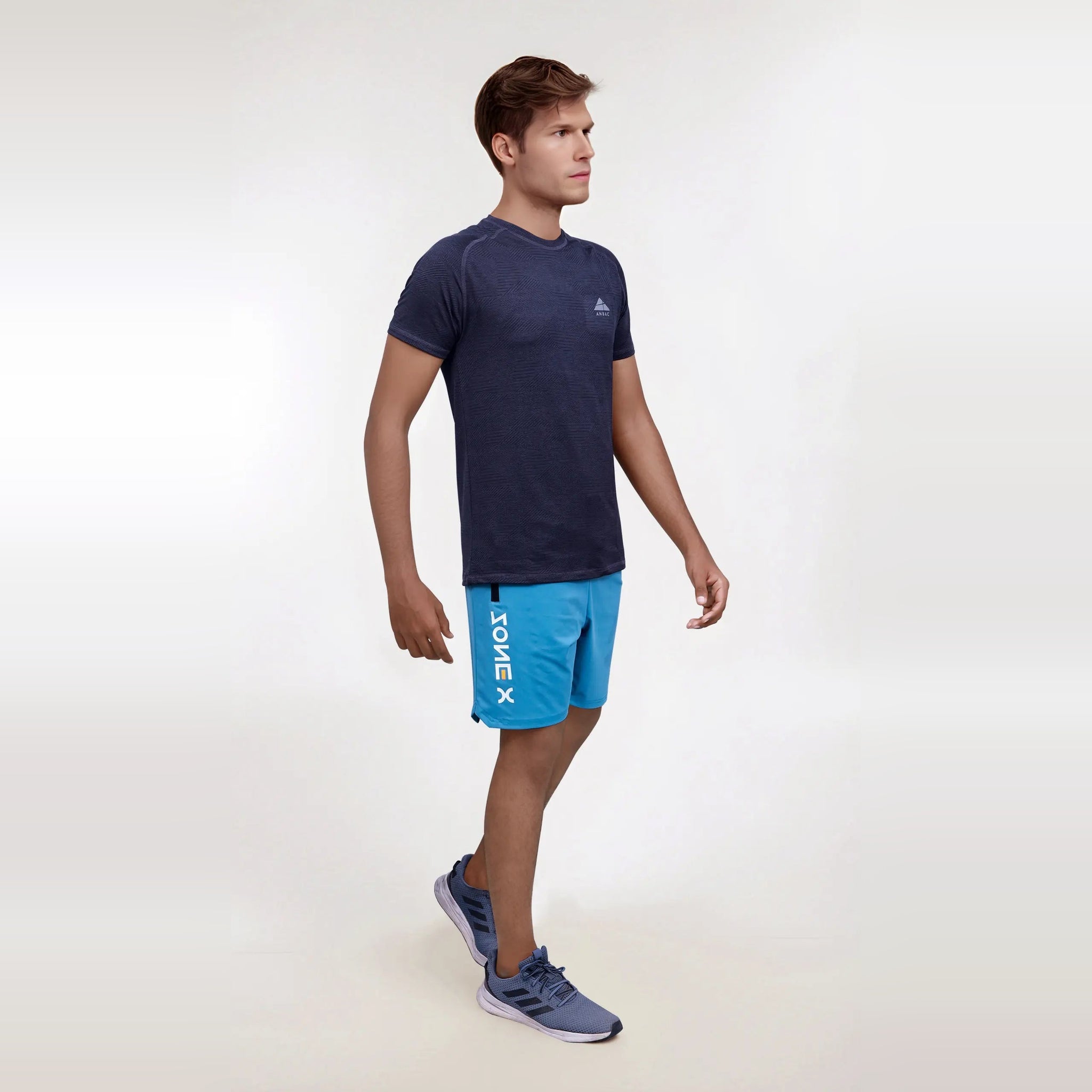 Man modeling a breathable, navy blue, men's dry-fit short sleeve crew neck t-shirt, perfect for workouts or everyday wear.