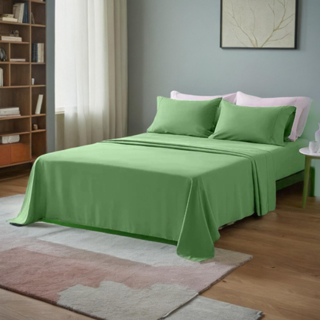 Luxurious green 300TC Egyptian cotton bed sheets on a queen-size bed, creating an inviting sleep space.