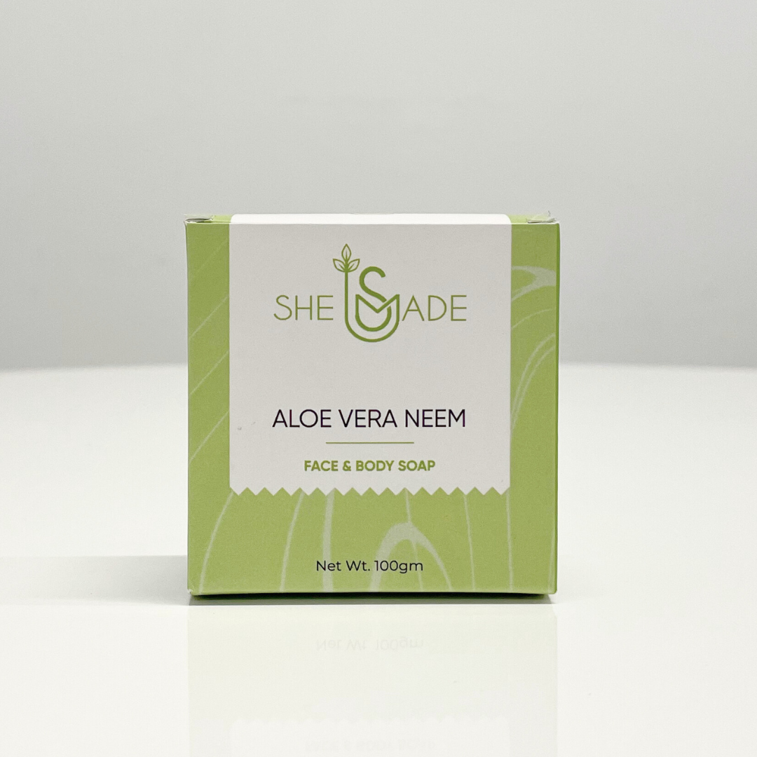 Handcrafted aloe vera and neem oil soap bar in its green packaging from SheSmade.