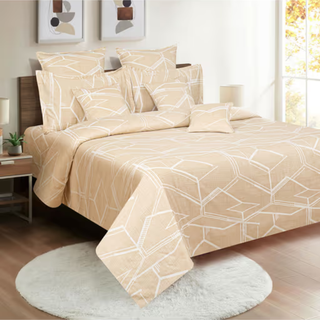 Beige king-size bedsheets with a geometric pattern of white hexagons, styled with matching pillowcases and cushion covers.