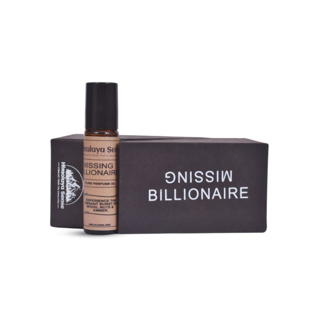 "Missing Billionaire" perfume roll-on with vibrant woody, nutty, and amber scents in a sleek black gift box.