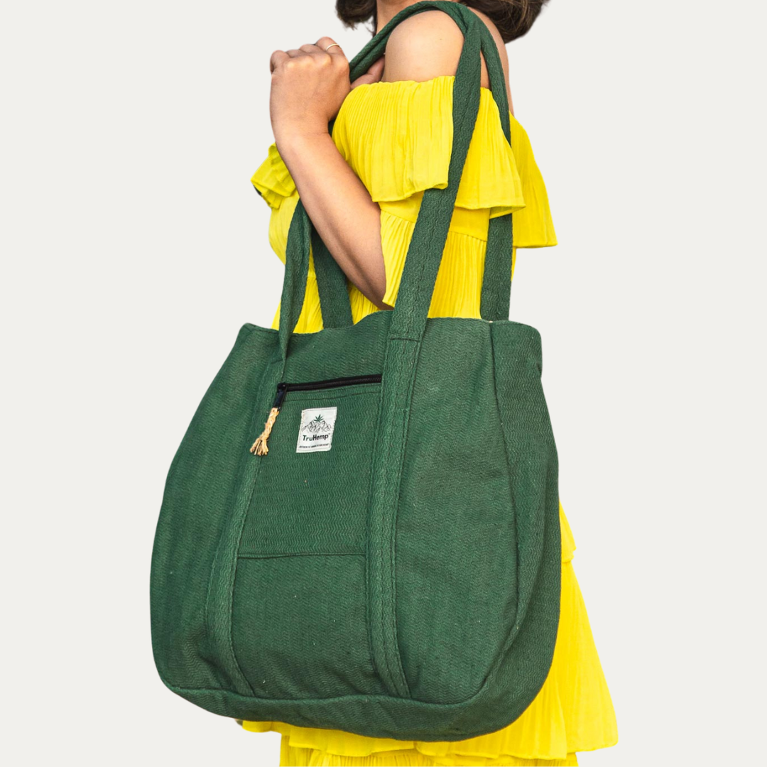 Woman carrying a spacious, forest green Himalayan Hemp Tote Shoulder Bag with zippered pocket.