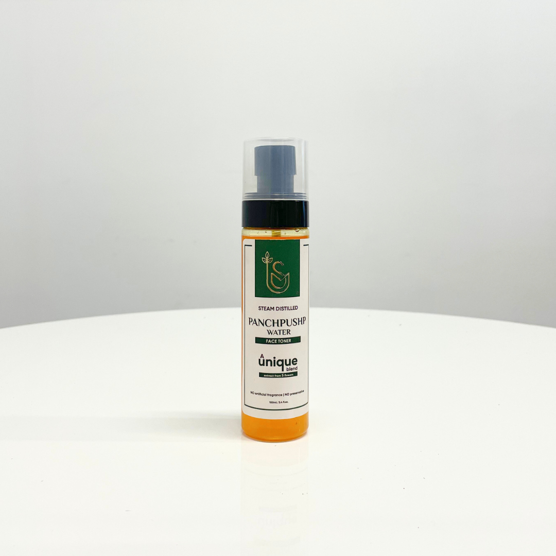 A bottle of Panchpushp Face Toner, a steam-distilled water blend, sits on a white table.