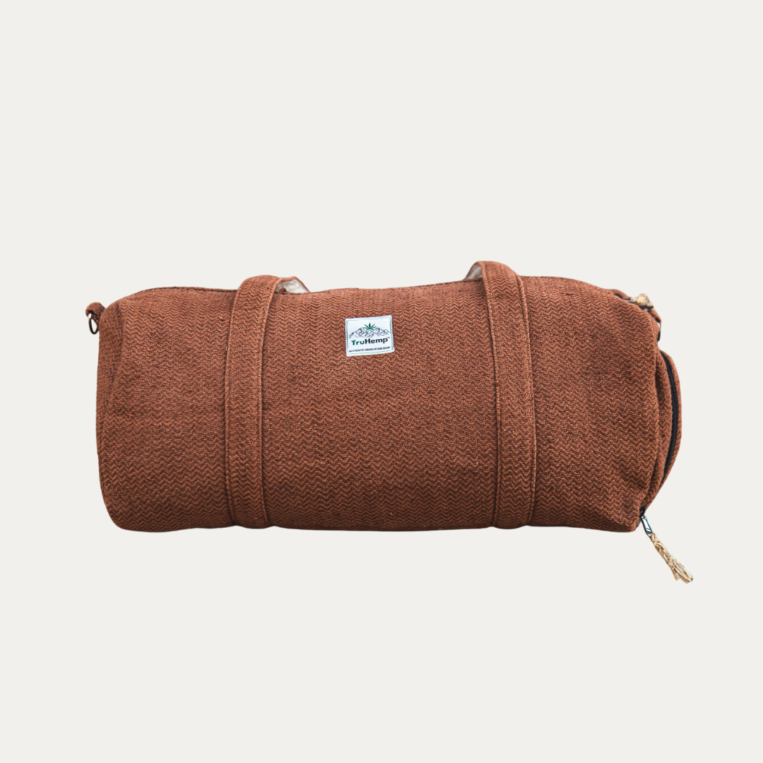 A sturdy brown hemp duffle bag with a dedicated shoe pocket, perfect for eco-conscious travelers.