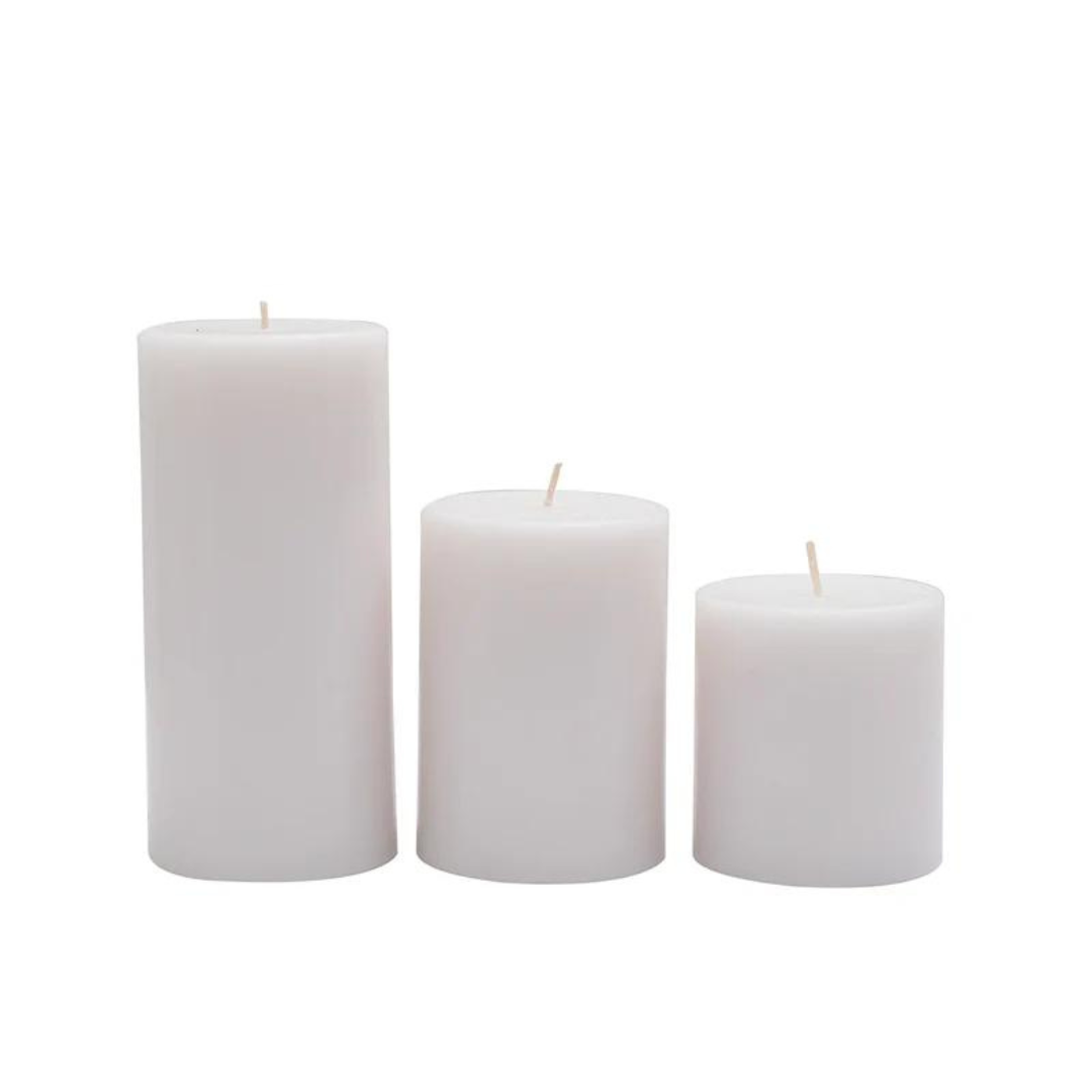 Set of three unscented white pillar candles in varying sizes, perfect for minimalist Scandinavian decor.