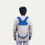 A person wearing a blue and beige "Handcrafted Trainer's Hemp Backpack with Pure Cotton Lining" on their back.