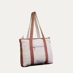 Eco-friendly hemp tote bag with brown straps and zippered pocket, perfect for corporate events or everyday use.