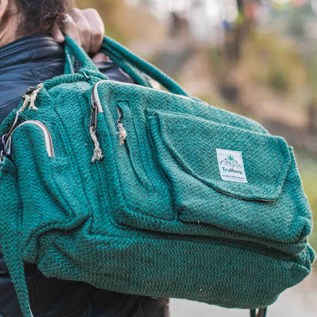 Stylish teal Himalayan Hemp Laptop Side Bag with multiple pockets, worn over the shoulder with adjustable strap.