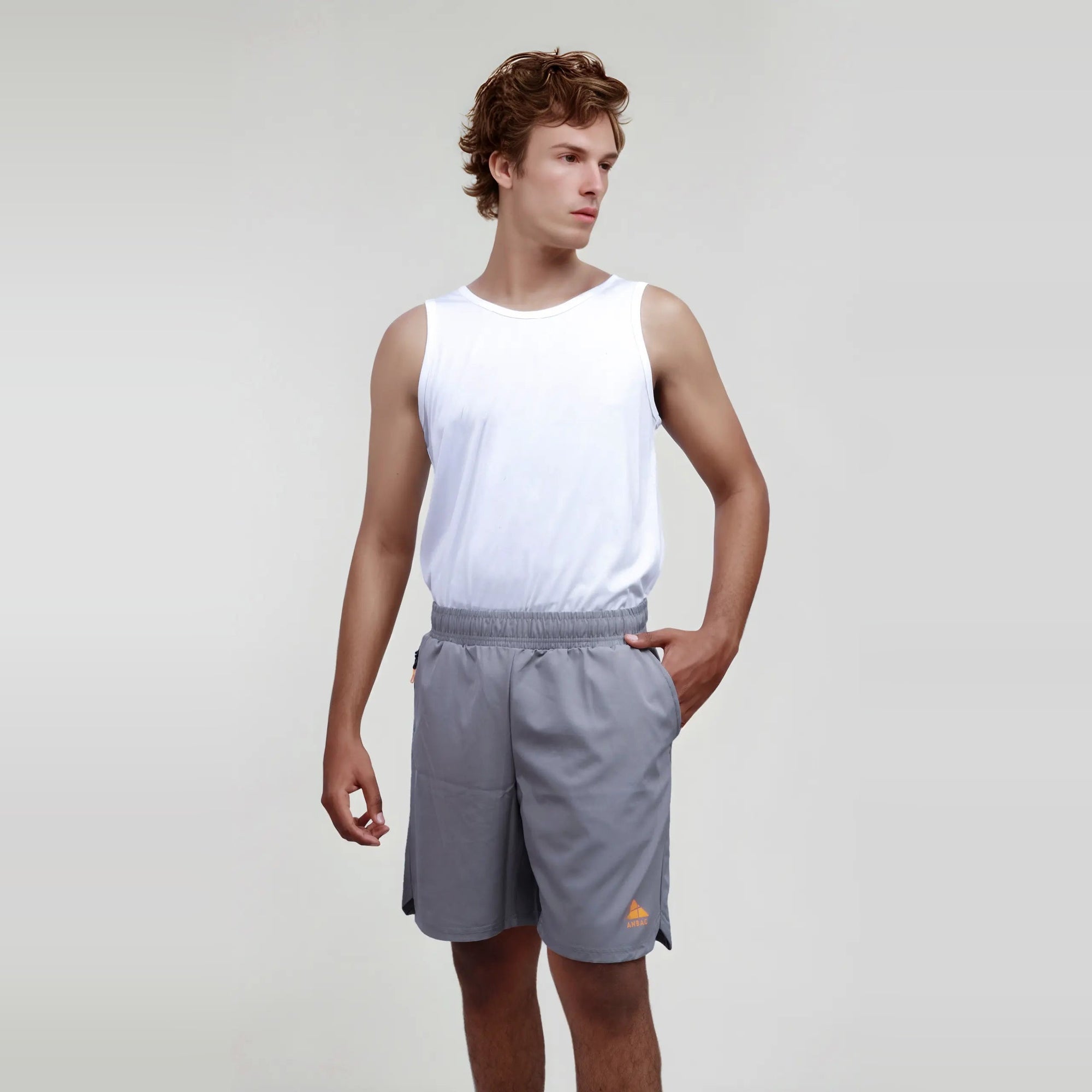 Man wearing gray wrinkle-free, dry-fit shorts ideal for sports and the gym.