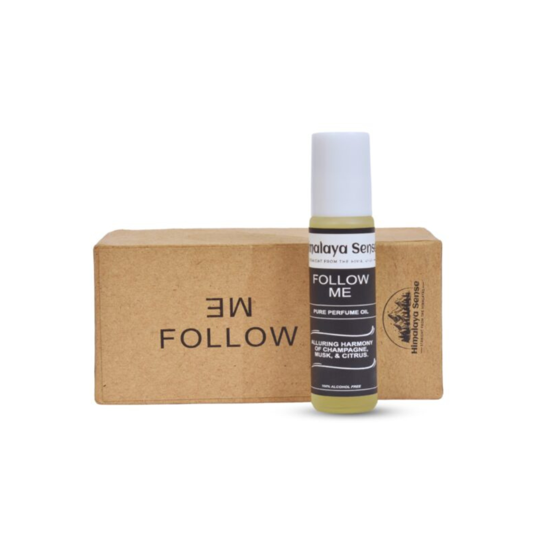 "Follow Me" natural perfume roll-on by Malaya Sense in its eco-friendly box. A women's fragrance with notes of champagne, musk, and citrus.