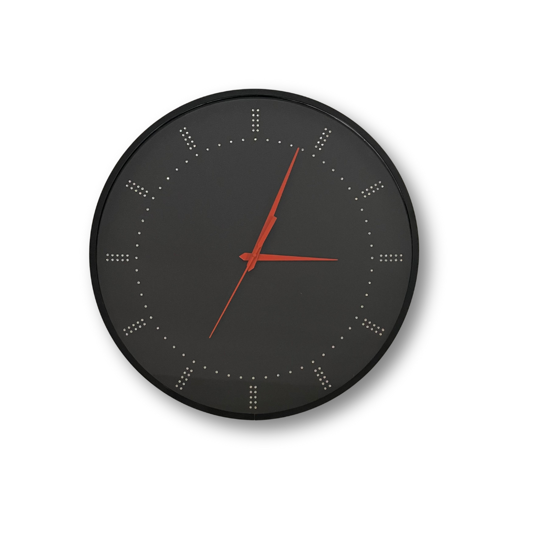 A minimalist black analog wall clock with red hands on a white background. This 18-inch clock adds a modern touch to any home or office.