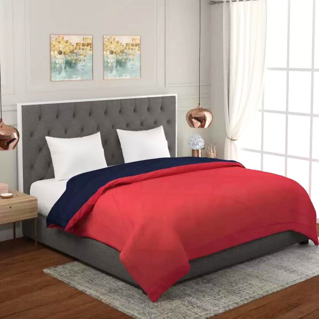 Red and blue Bellolin Microfibre Reversible Comforter on a bed. This double bed comforter is soft, comfortable, lightweight and breathable.