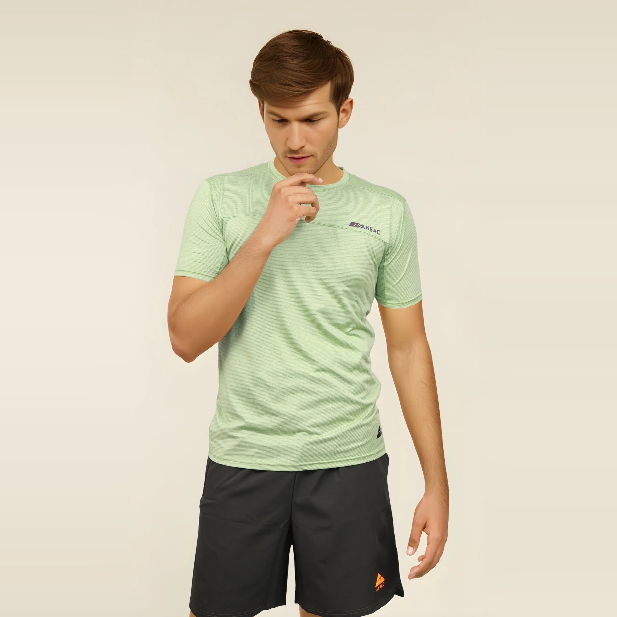 Man wearing a slim fit, light green, short sleeve T-shirt.