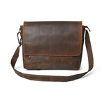 Stylish brown top grain leather crossbody messenger bag with adjustable strap, perfect for carrying a laptop and everyday essentials.