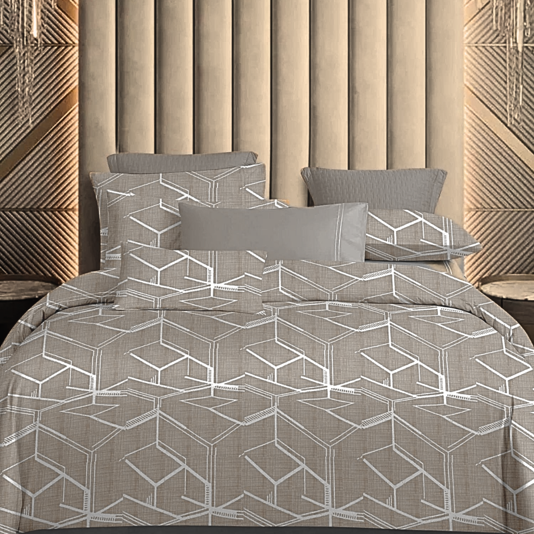 King-size bedsheets in taupe with a modern white geometric hexagon pattern. Several pillows are arranged at the head of the bed.