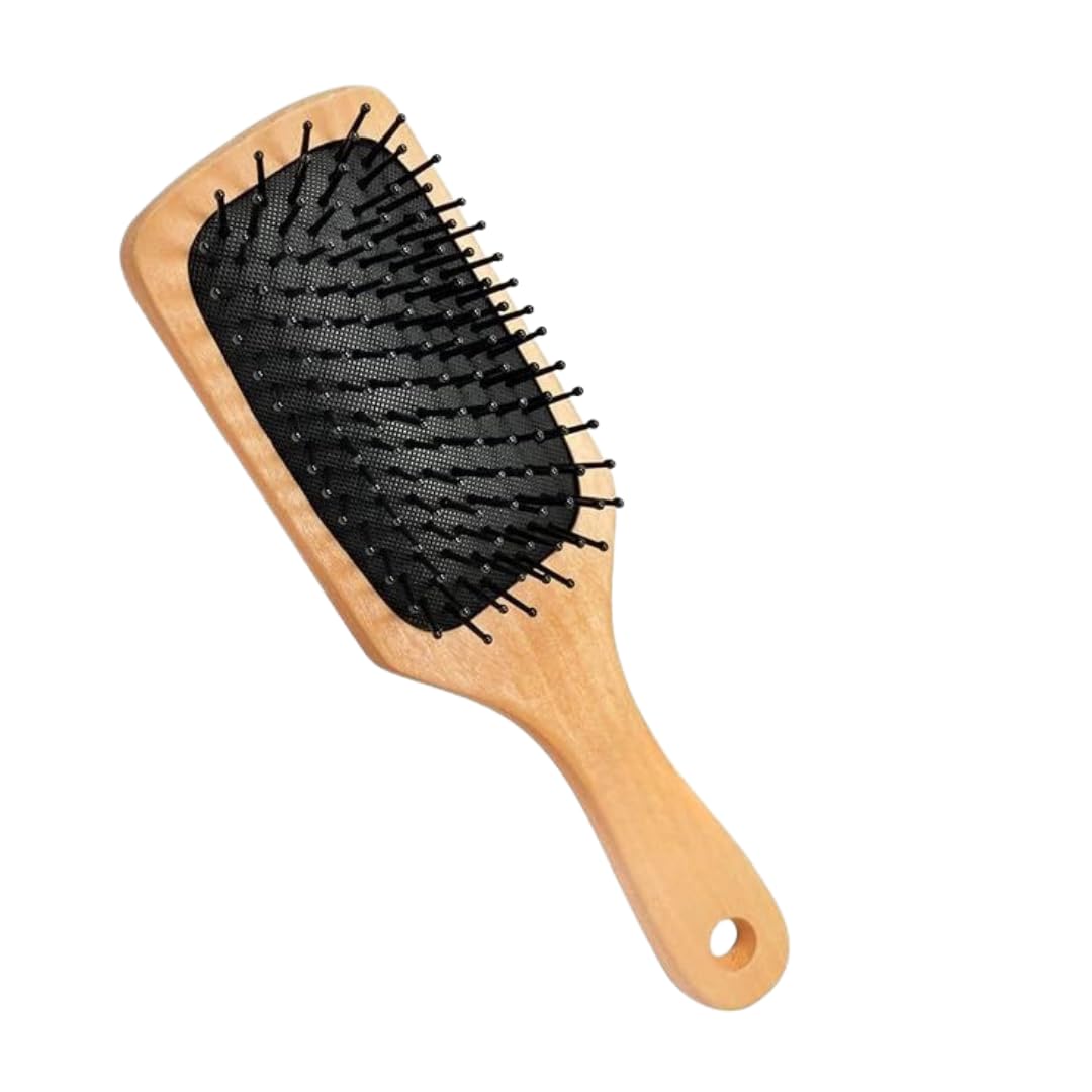 Ergonomic wooden hairbrush with black cushioned base and rounded bristles, angled view.