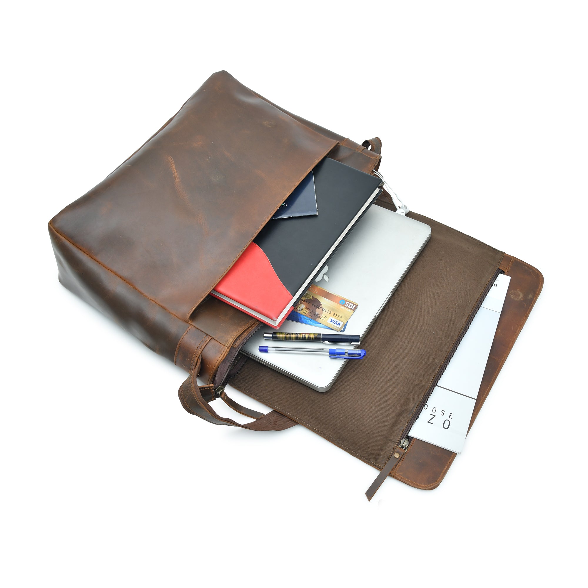 Open brown leather laptop messenger bag, showing inner pockets filled with a laptop, notebook, and pens.