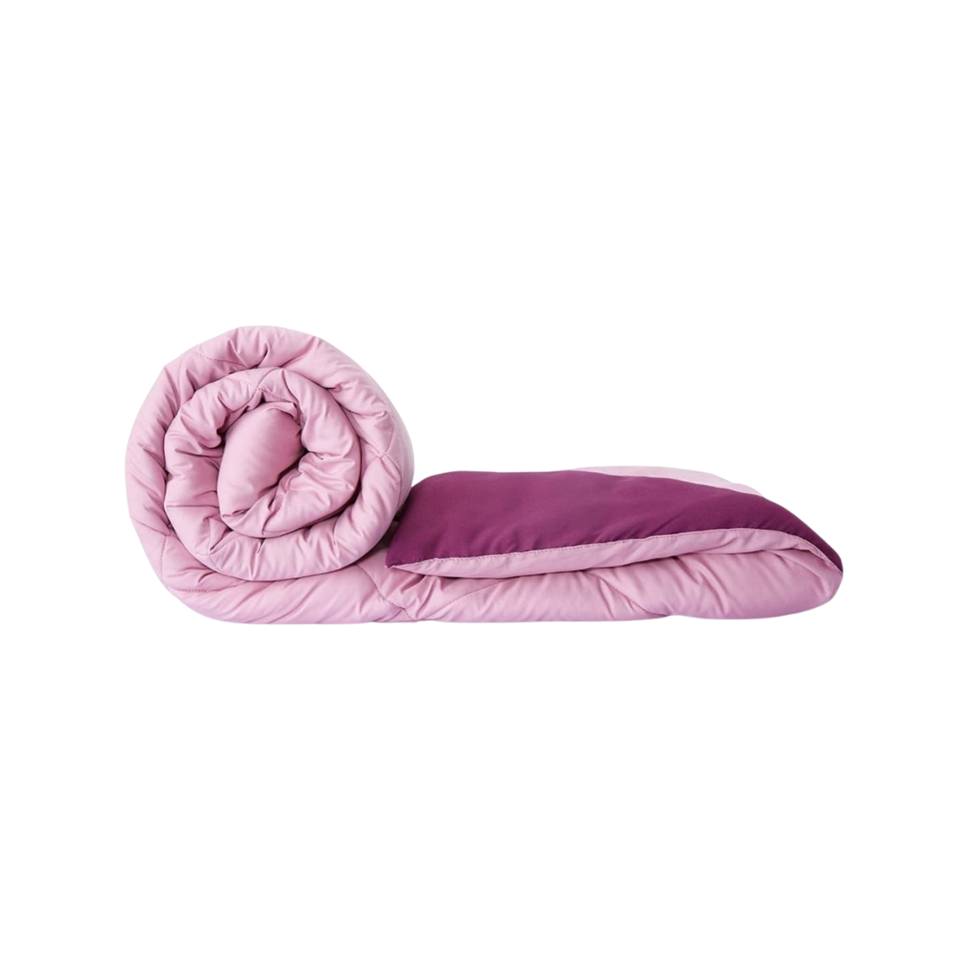 Bellolin Microfiber Reversible Comforter in pink, rolled up to showcase its softness and lightweight design. Perfect for a double bed.