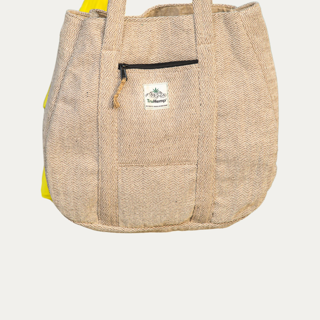 Stylish beige Himalayan hemp tote bag with zippered pocket and chevron pattern, perfect for eco-conscious women.