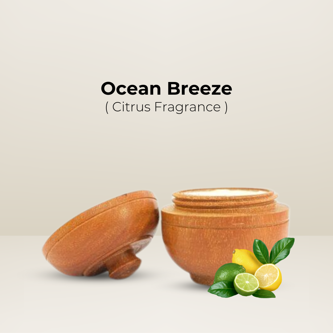 Natural Solid Body Wax Perfume, Ocean Breeze (Citrus Fragrance) in an open wooden jar with fresh lemons and limes.