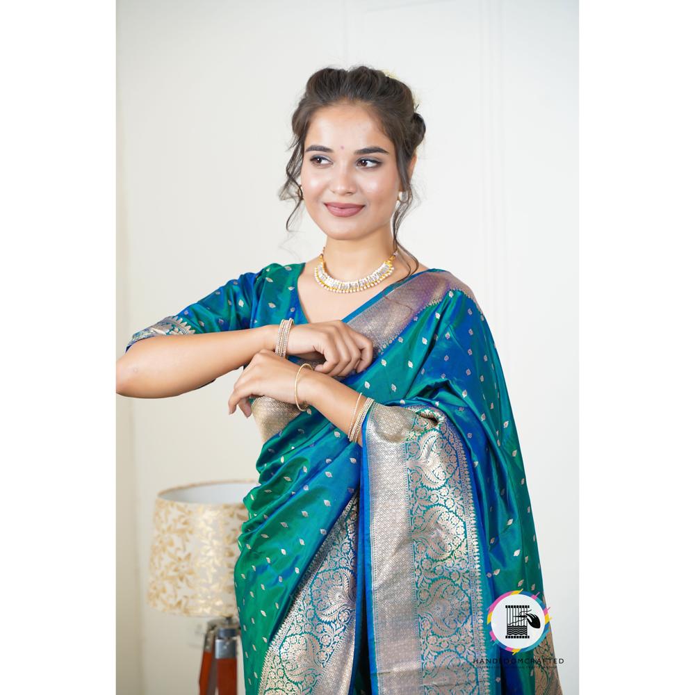 Woman wearing a blue and teal Blue Printed Pattern Soft Banarasi Tissue Silk Saree with intricate gold detailing.