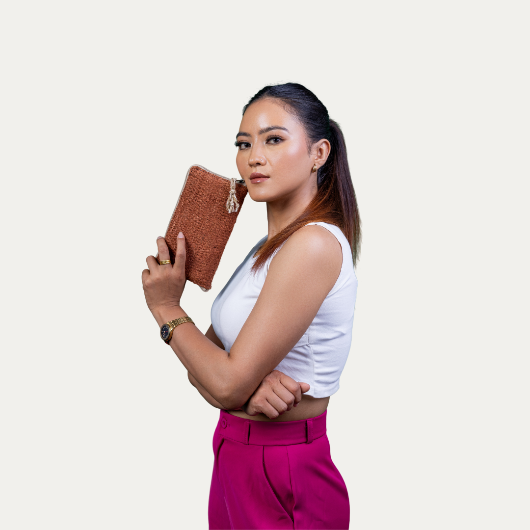 Stylish woman holding a brown Compact Light Weighted Maya Hemp Clutch Wallet.