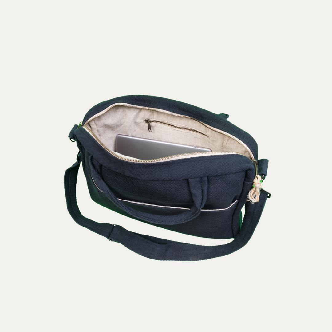 Open, navy blue hemp and cotton blend side bag with a tablet inside, showing the spacious interior and durable construction.