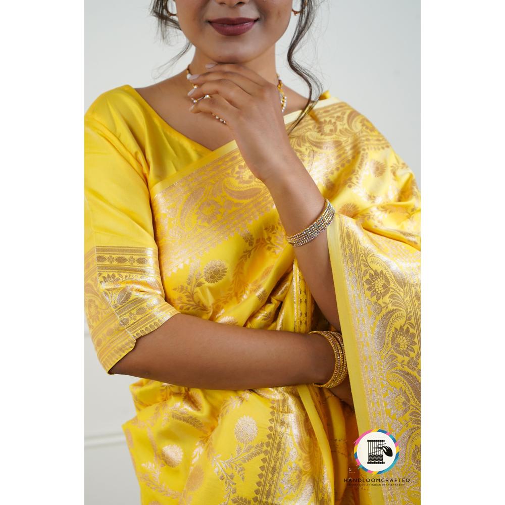 Woman wearing a Sunflower Yellow Banarasi Tissue Silk Saree with intricate gold patterns, perfect for festive occasions.