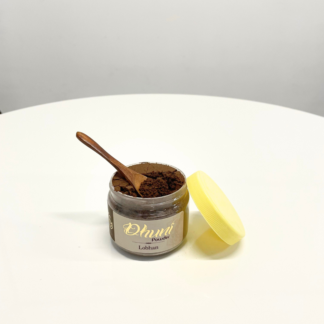 A jar of Lobhan Dhuni Powder with a wooden spoon, ready to be used for traditional incense burning rituals.