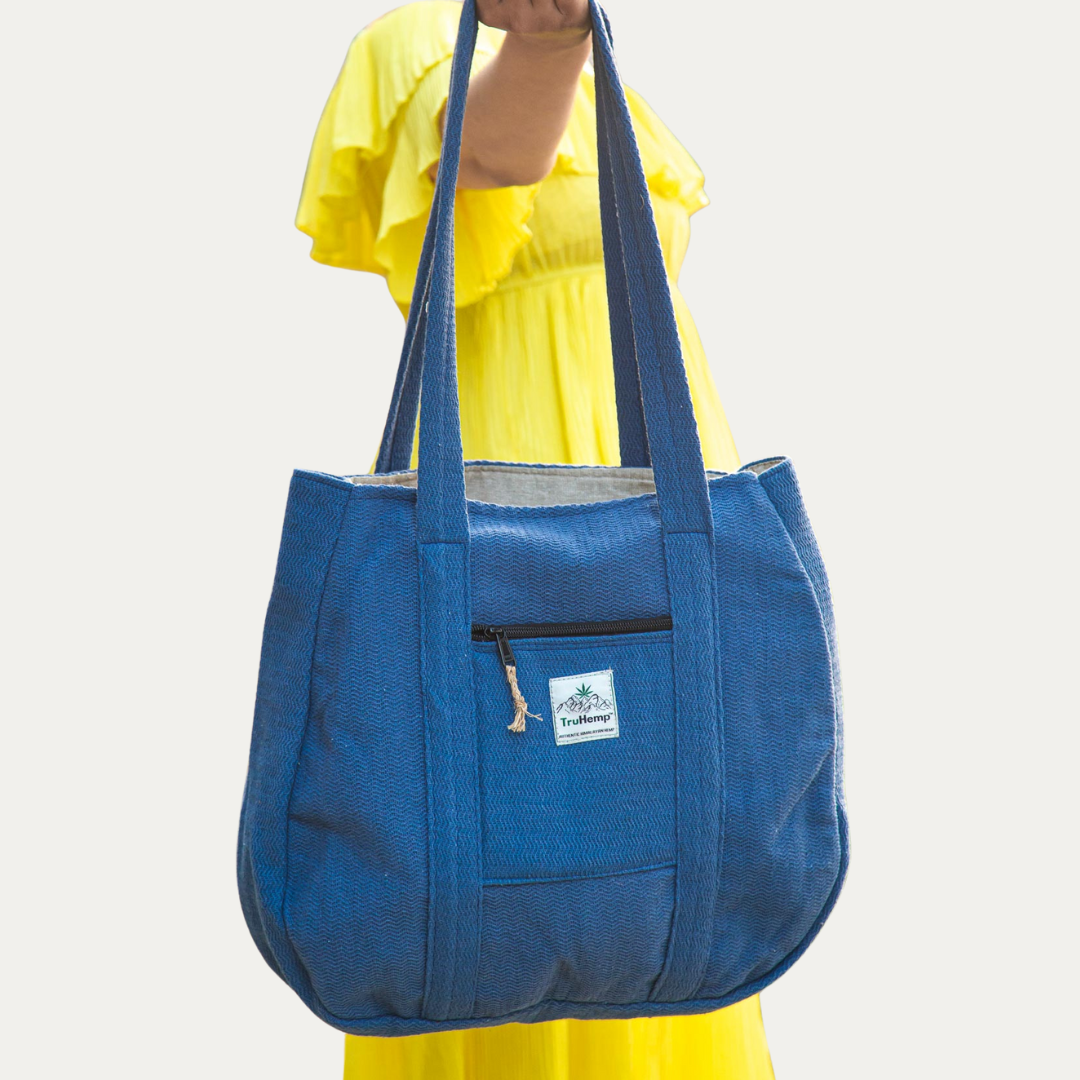 Stylish blue Himalayan hemp tote bag with shoulder straps and zippered pocket, perfect for eco-conscious women.