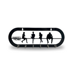 Black metal key holder for wall mounting with "Happy Home" inscription and silhouette cutouts of people sitting on a bench.