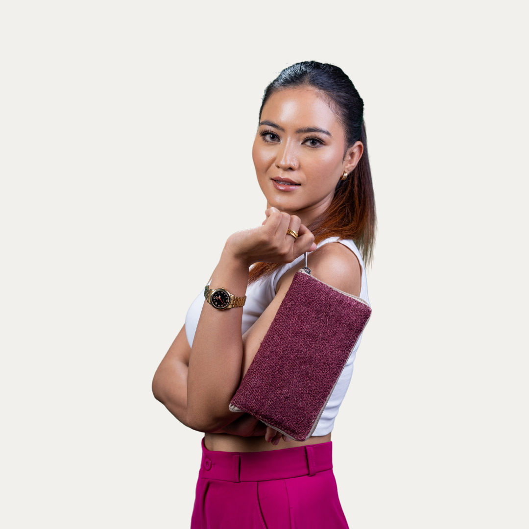 Stylish woman holding a maroon Compact Light Weighted Maya Hemp Clutch Wallet, perfect for carrying essentials in style.