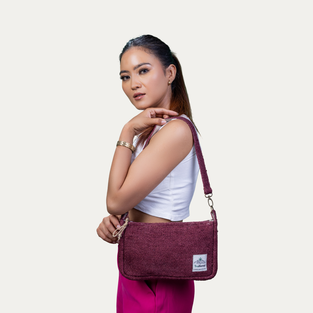 Stylish woman models a maroon "Sling Hemp Shoulder Bag" with adjustable strap. Eco-friendly and perfect for everyday use.