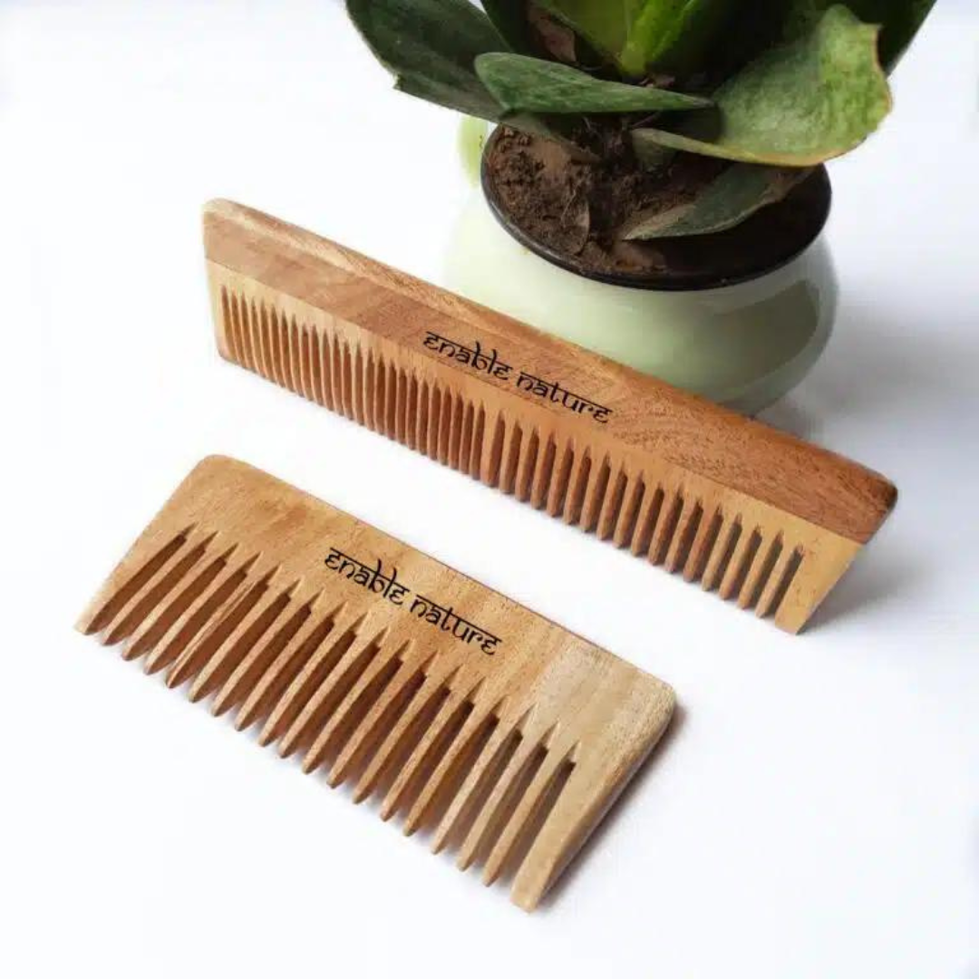 Two Enable Nature wooden hair combs lie side-by-side, showcasing their smooth, handcrafted finish.