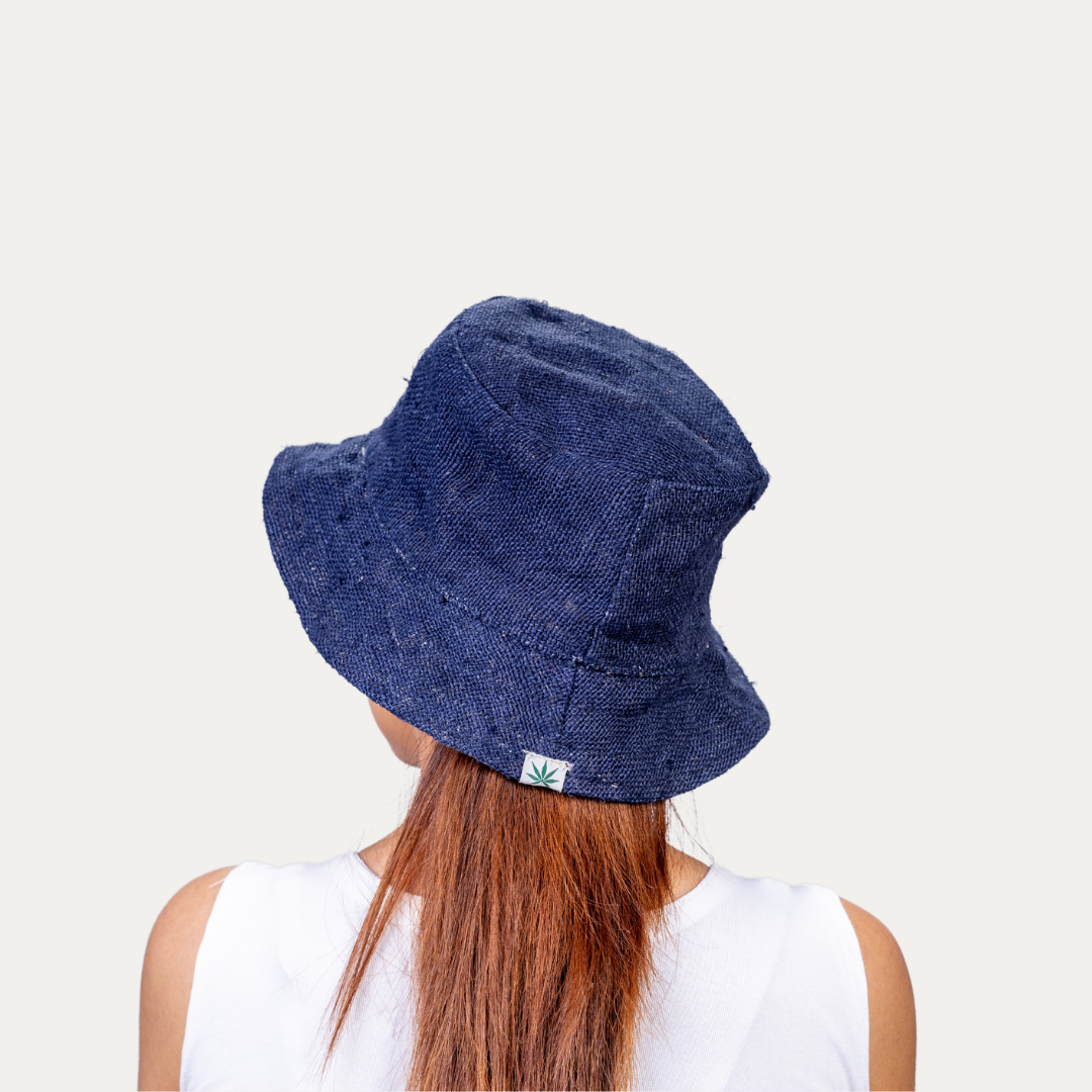 Woman wearing a stylish blue hemp bucket hat, offering UV protection and comfortable airflow.