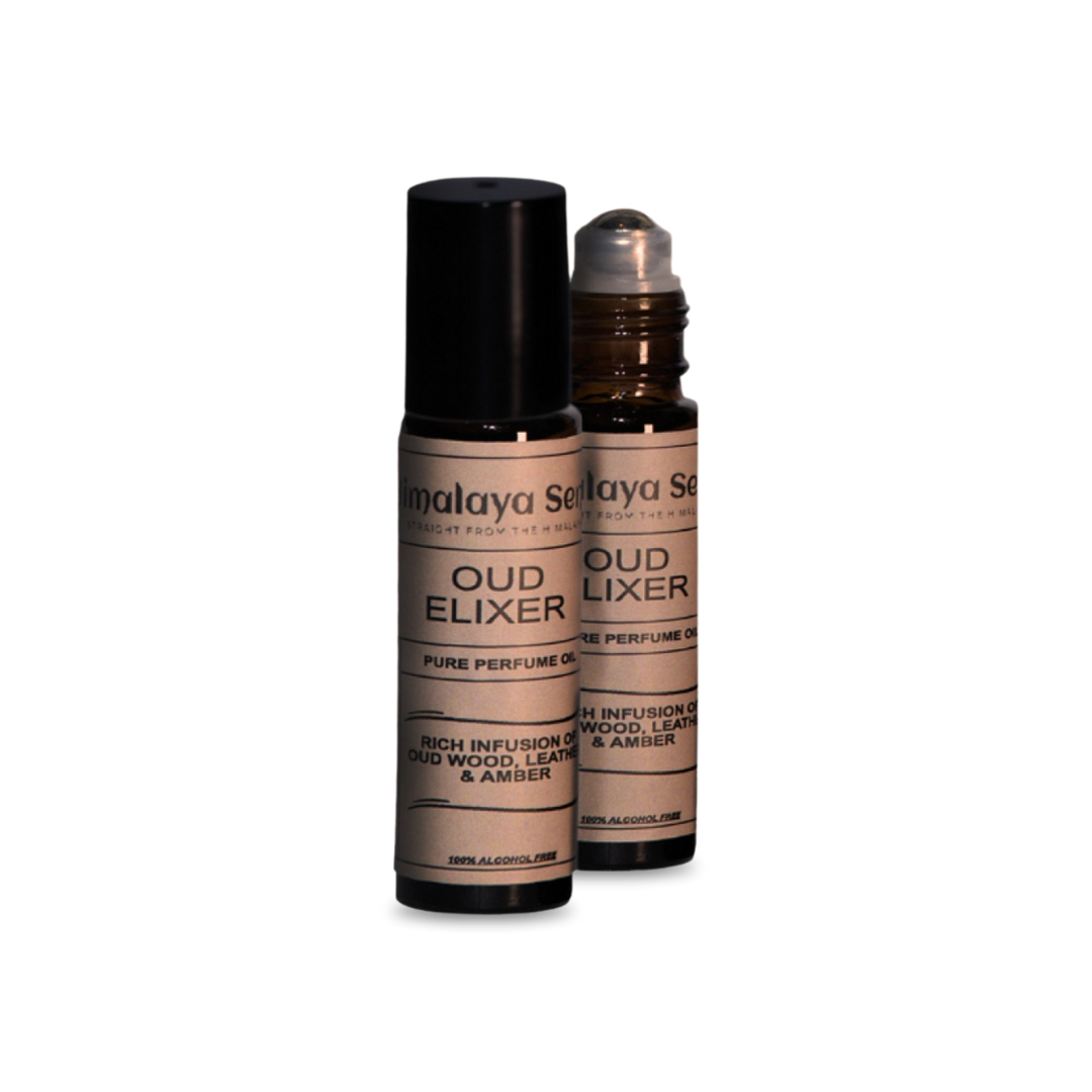 Two roll-on bottles of Natural Perfume Oud Elixer for men. This alcohol-free perfume oil is a rich infusion of oud wood, leather, and amber.